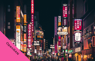 Image of Japanese street with brightly coloured lit signs